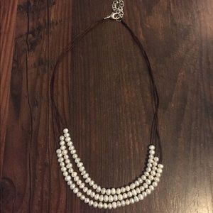 Brown leather a pearl necklace